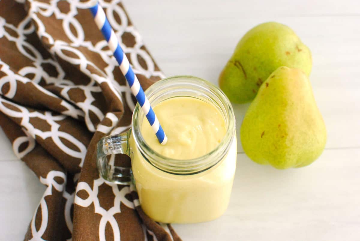 Overhead shot looking at a creamy pear mango smoothie.