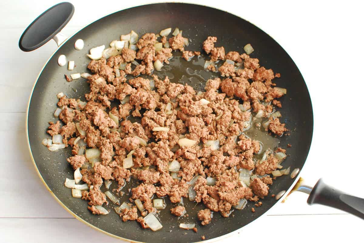 Ground beef and onion sauteed together in a skillet.
