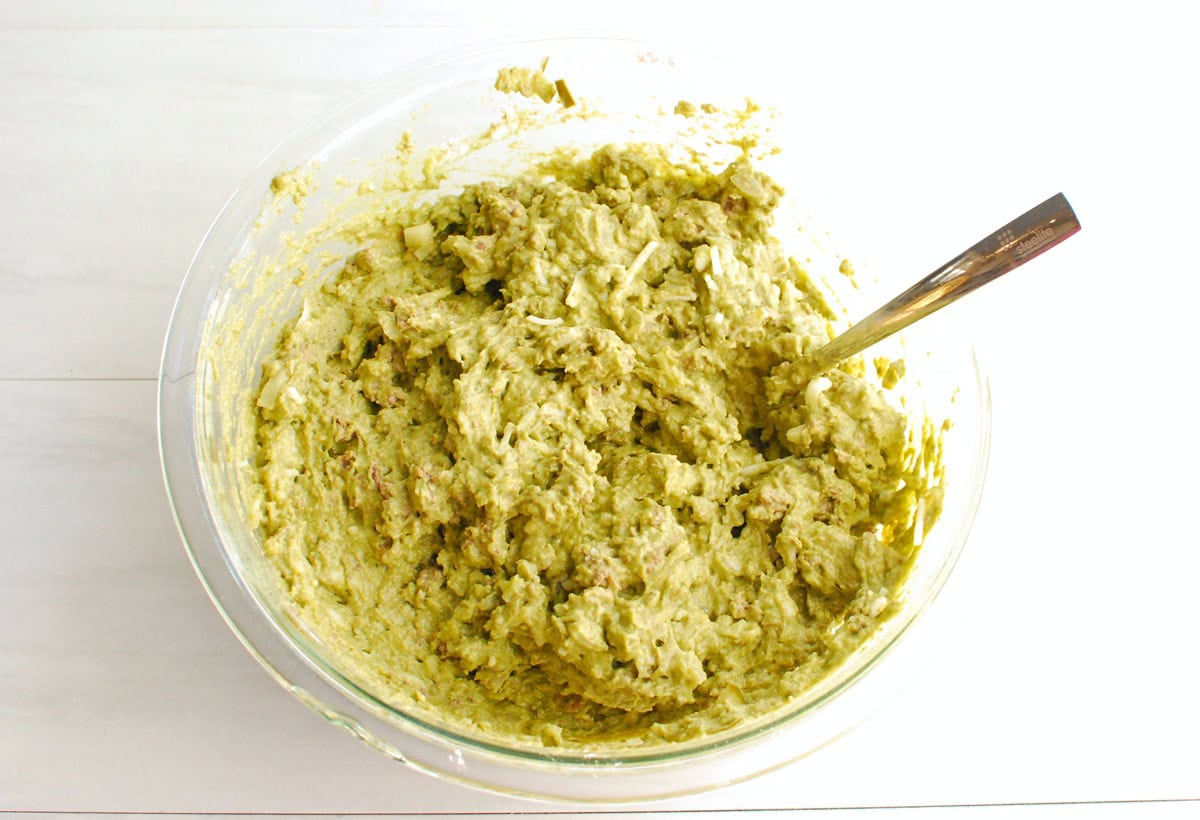 Thick muffin batter in a glass mixing bowl.