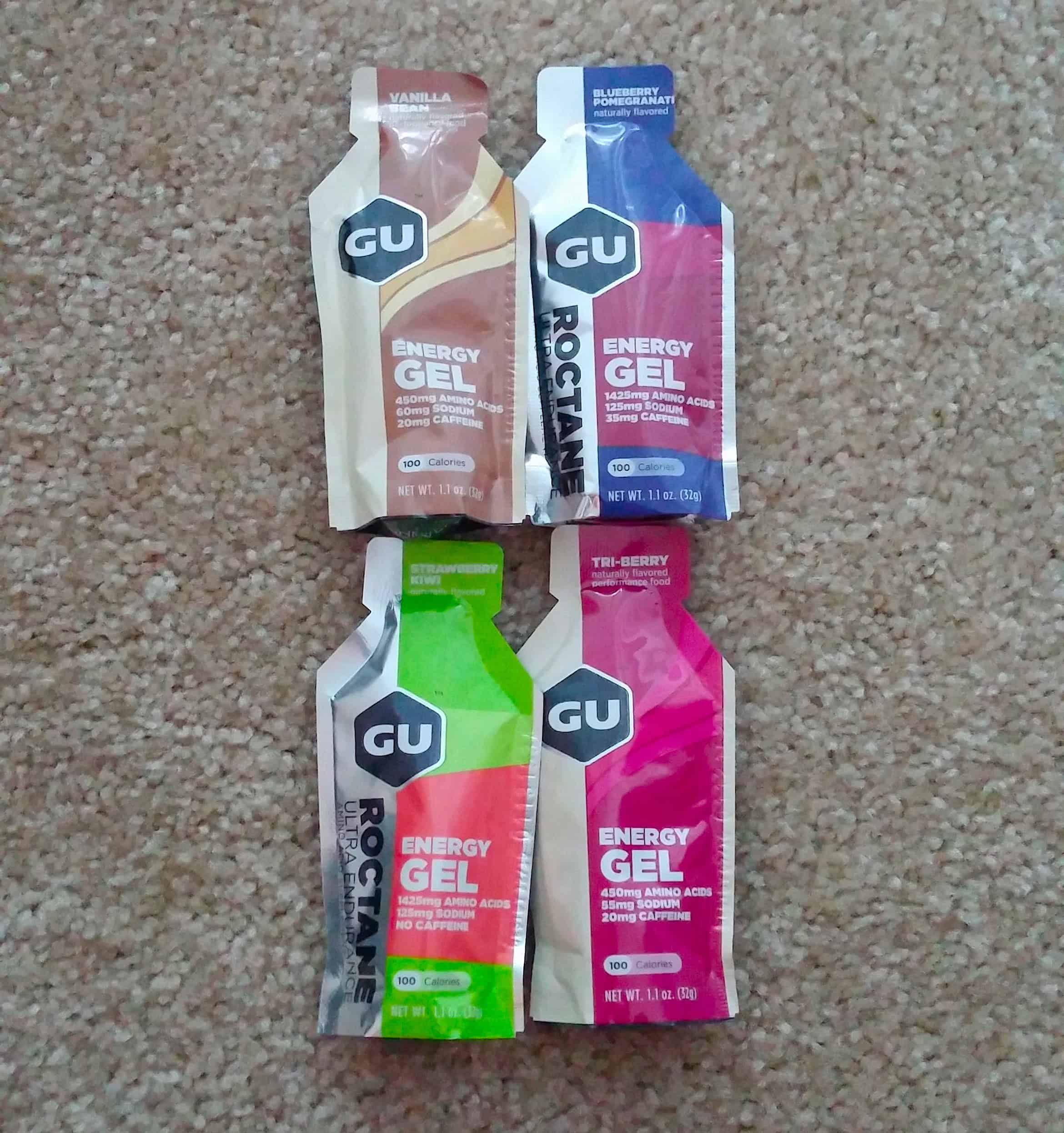 Four different energy gels on the floor.