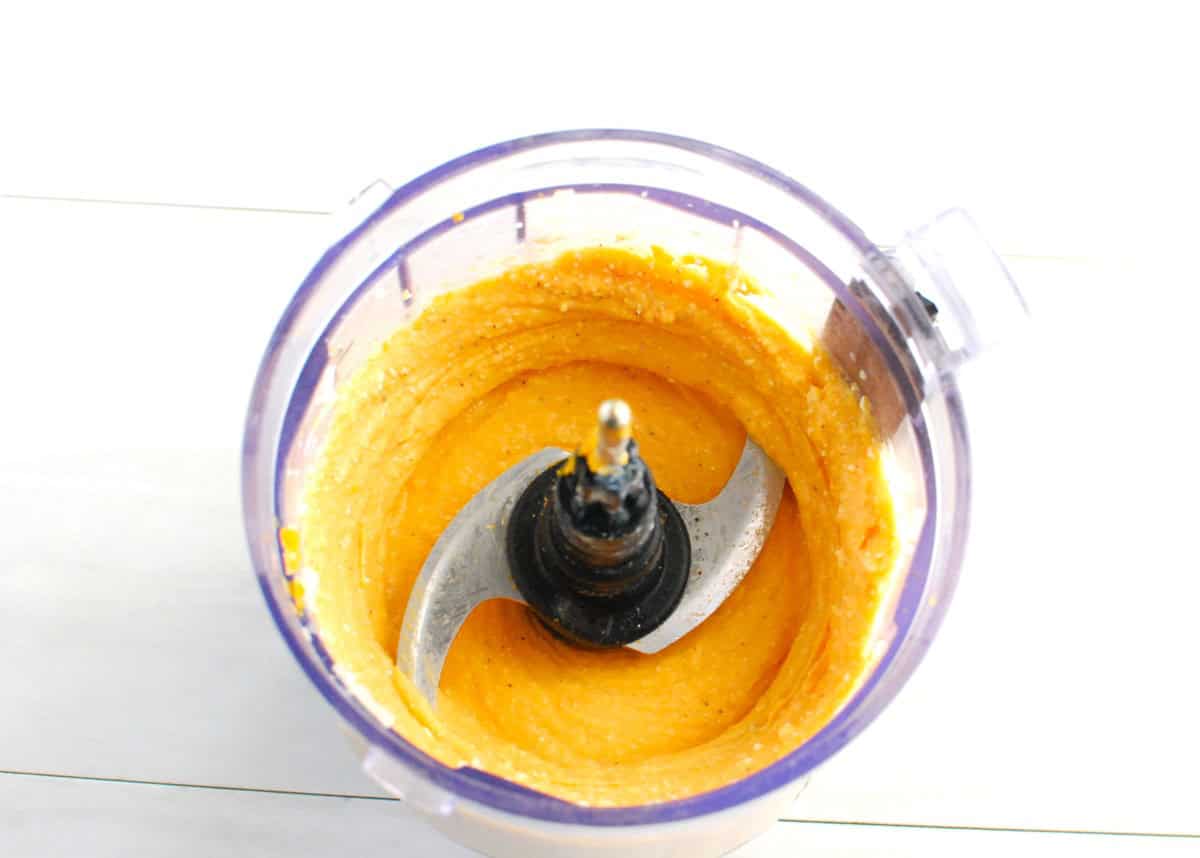 Sweetpotato, cheddar cheese, cottage cheese, garlic powder, salt, and pepper blended together in a mini food processor bowl.