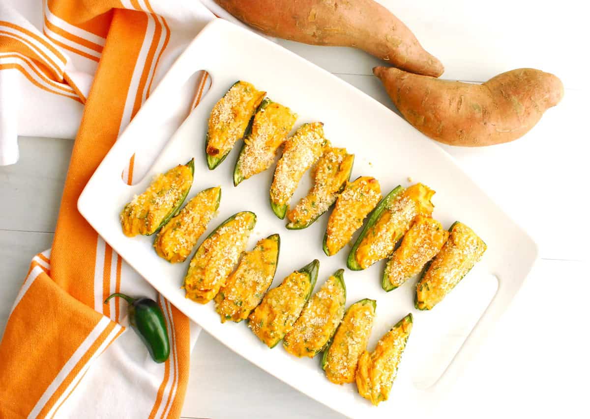 A white platter full of sweetpotato jalapeno poppers.