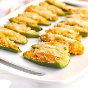 Sweetpotato cheddar cottage cheese jalapeno poppers on a white plate.