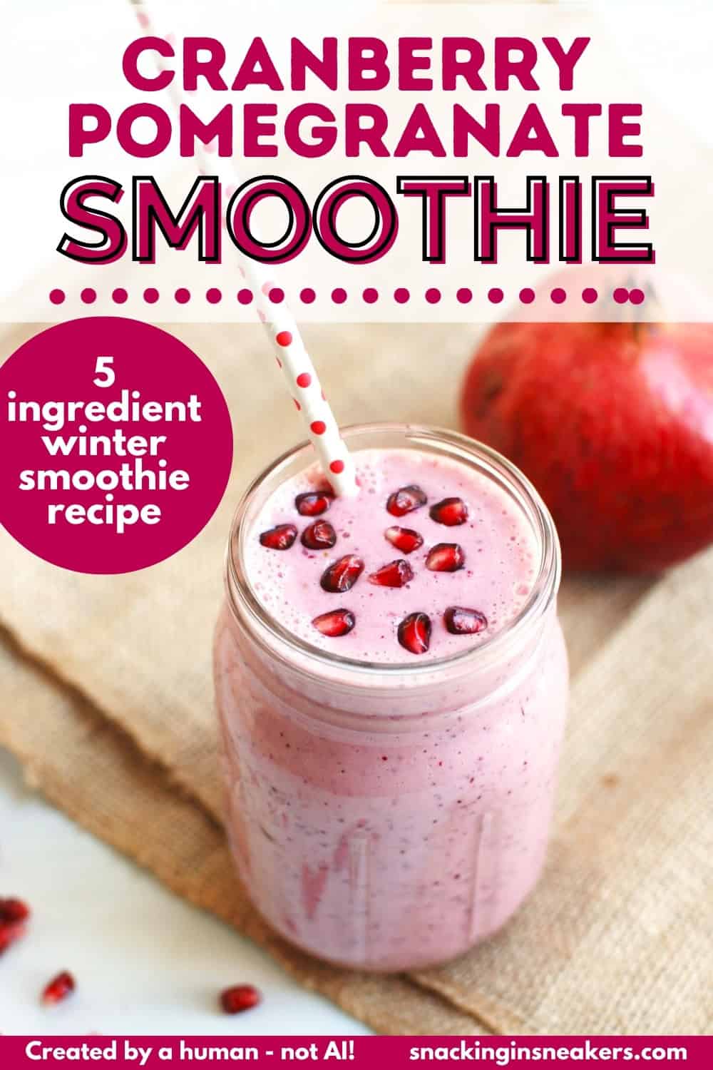 A mason jar filled with a pomegranate cranberry smoothie, garnished with pomegranate arils, and a text overlay with the name of the recipe.