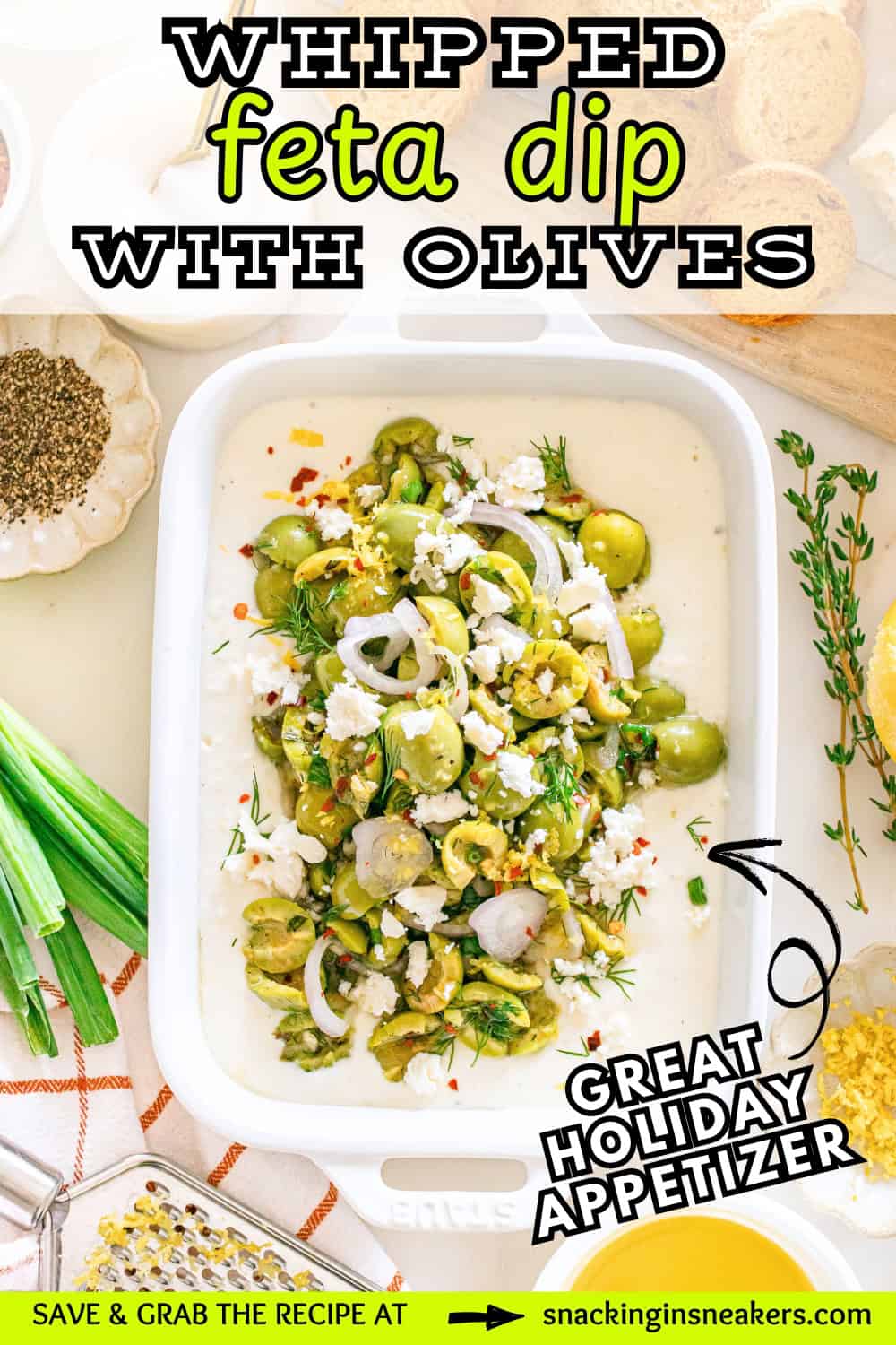 A dish filled with whipped feta dip with an herby olive topping, with a text overlay with the name of the recipe.