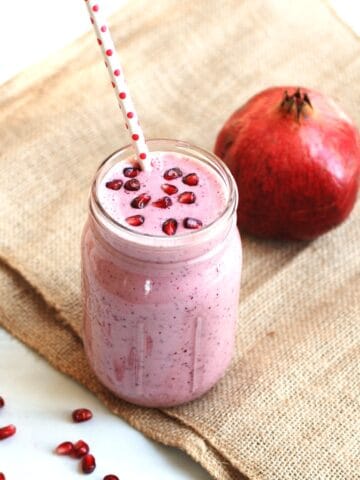 A cranberry pomegranate smoothie in a mason jar.