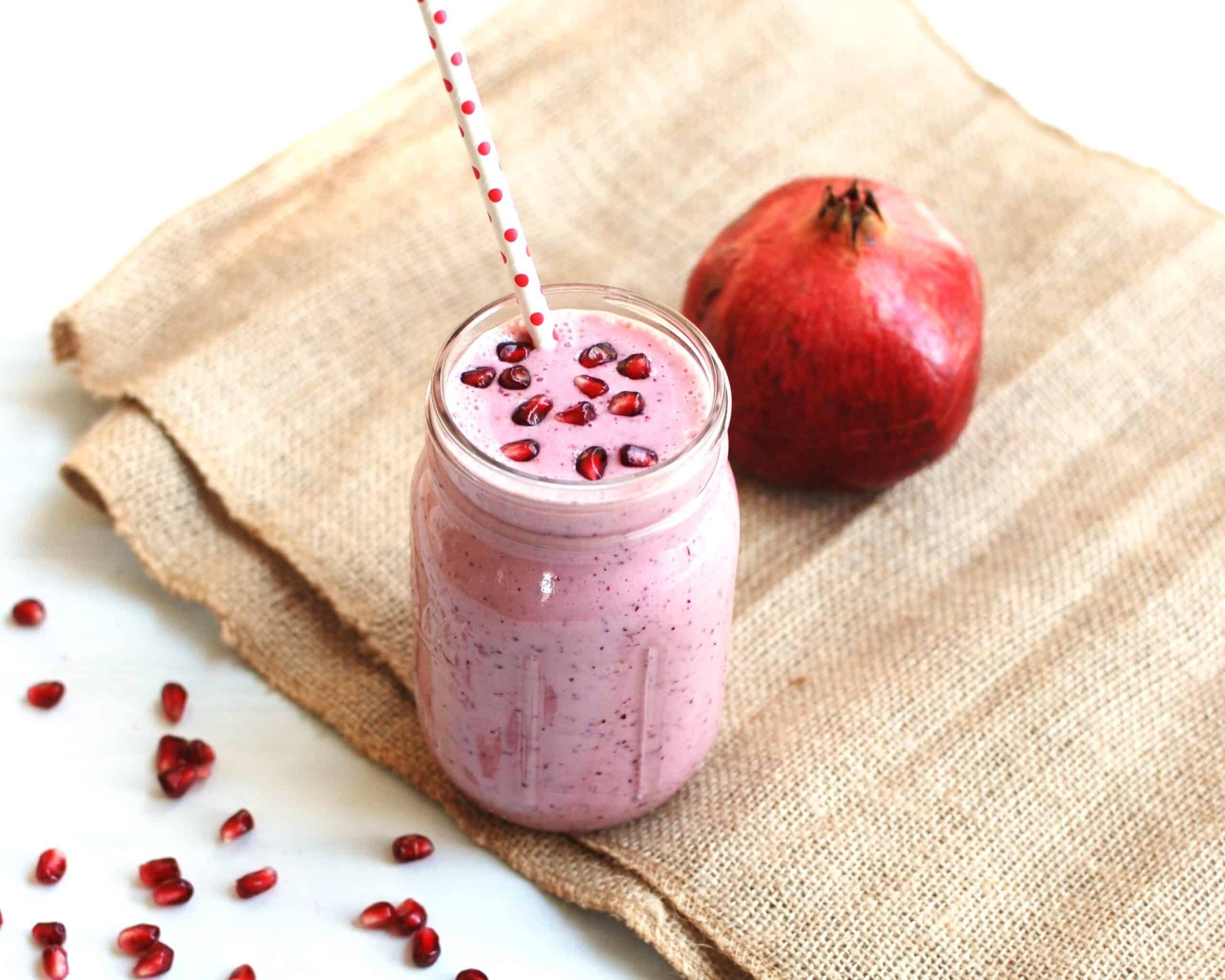 A cranberry pomegranate smoothie in a mason jar.