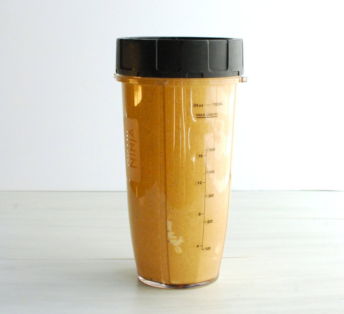 All of the pancake ingredients combined in a blender cup.