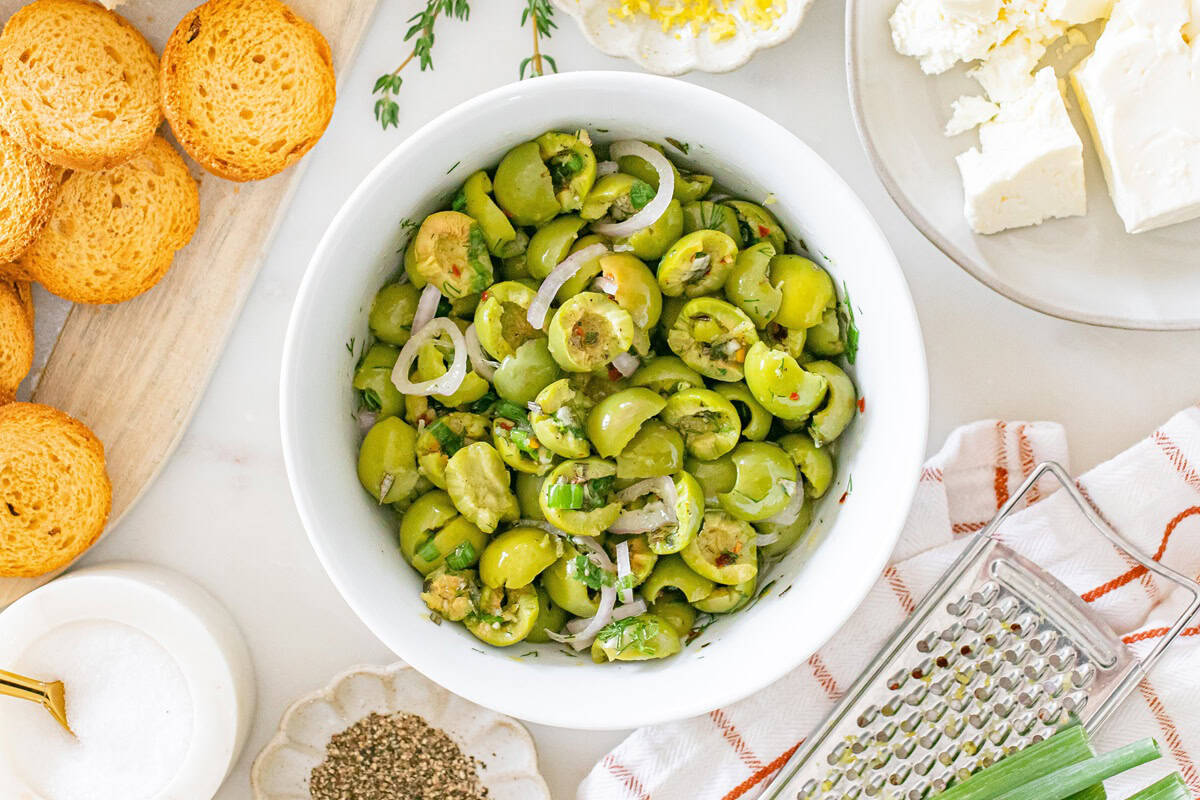 The olive topping mixed together in a white bowl.