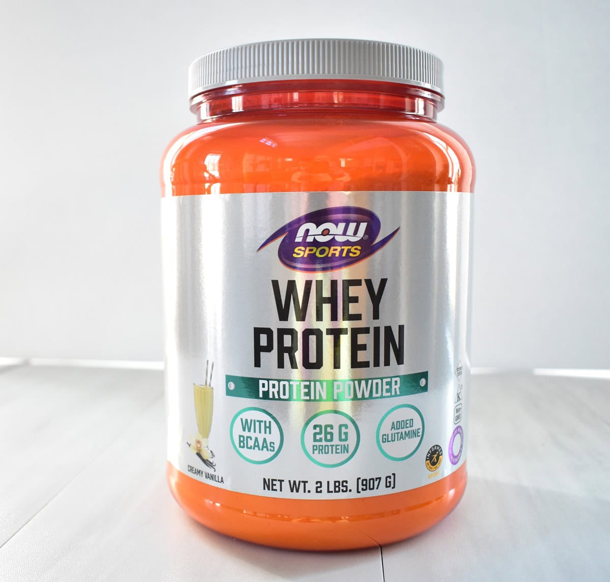 A container of vanilla whey protein powder.