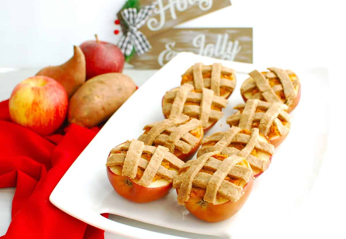 A platter of baked apples stuffed with sweetpotato filling and topped with pie crust.