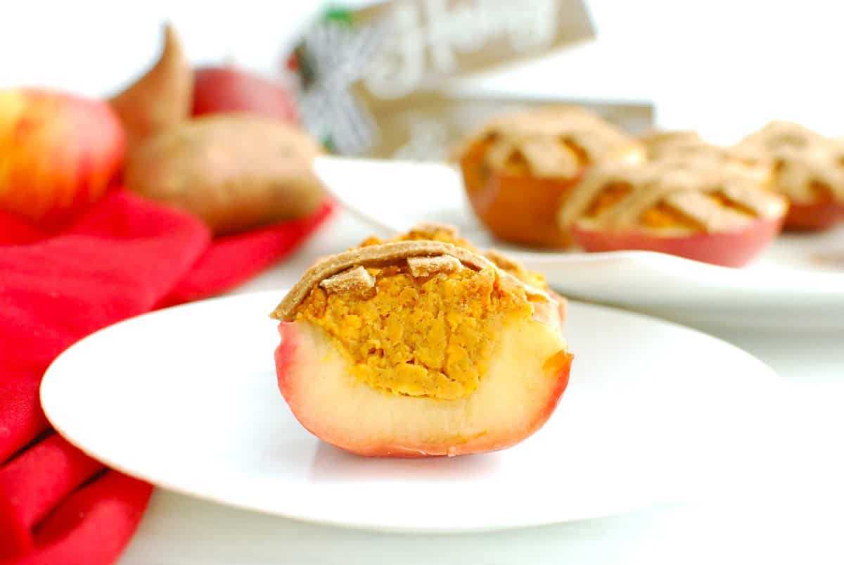 A baked apple cut in half showing the sweetpotato pie filling.