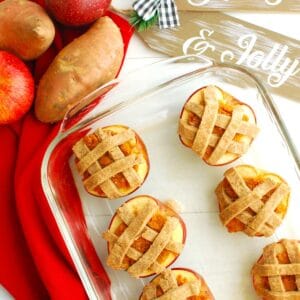 Several sweetpotato stuffed baked apples in a glass casserole dish.
