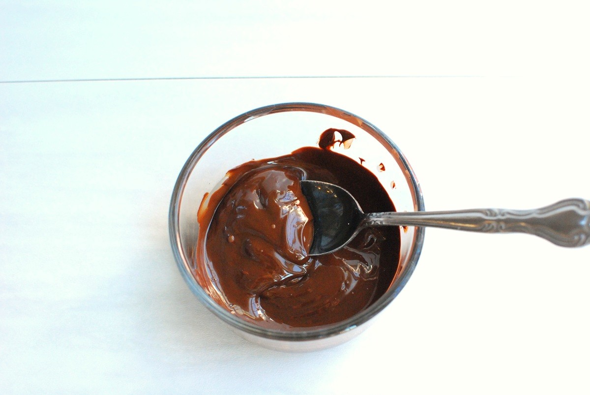 Melted chocolate in a glass bowl.