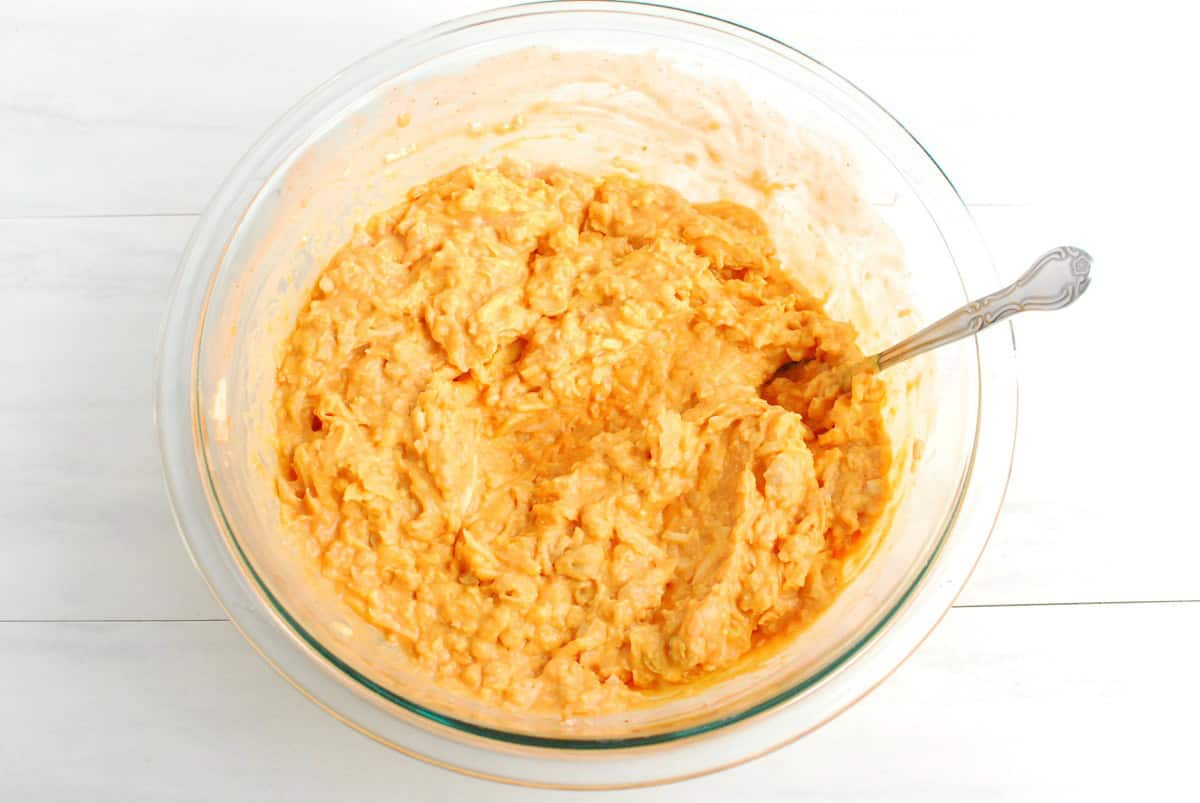 Dip ingredients mixed together in a glass mixing bowl.