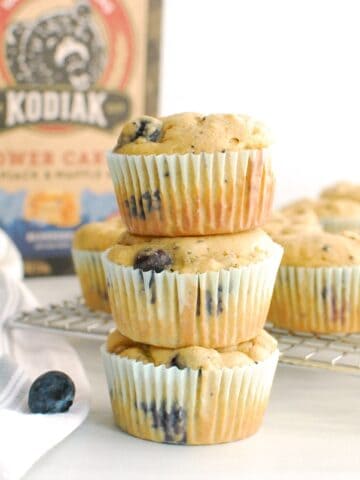 A stack of three Kodiak Cakes blueberry muffins.