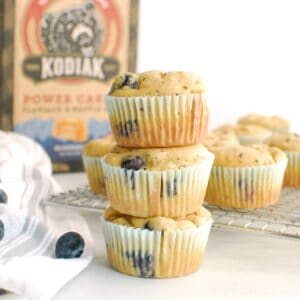 Three Kodiak Cakes blueberry muffins stacked on top of each other.