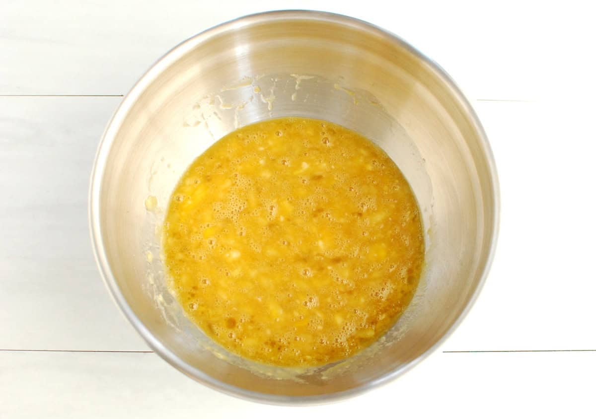 Banana, egg, maple syrup, oil, and vanilla whisked together in a bowl.