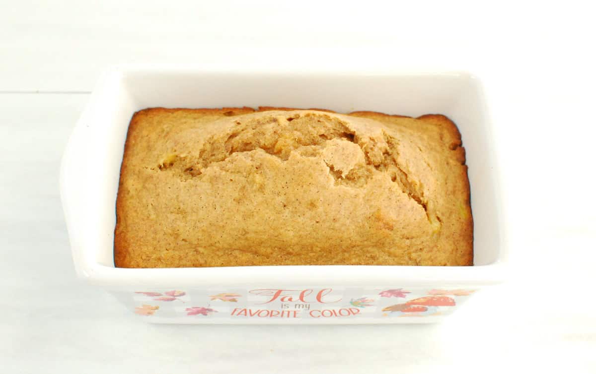 A mini loaf pan with just-baked banana bread.