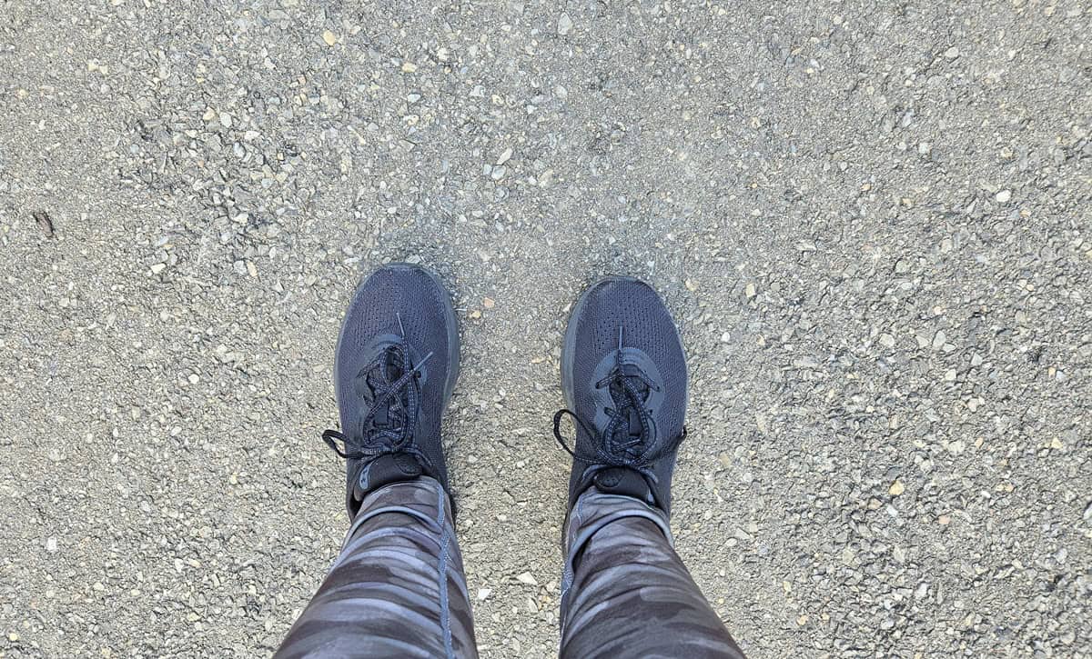 Sneakers on pavement while out for a walk.
