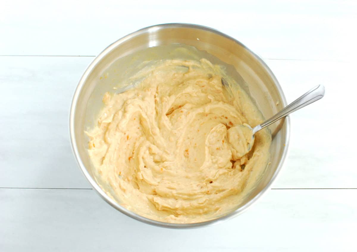 Sweetpotato, yogurt, peanut butter, maple syrup, and vanilla mixed together in a bowl.