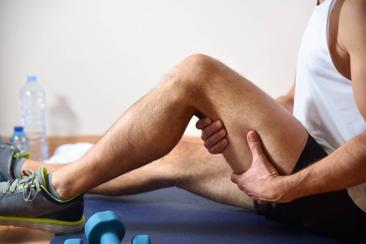 A man with sore hamstrings after exercise.