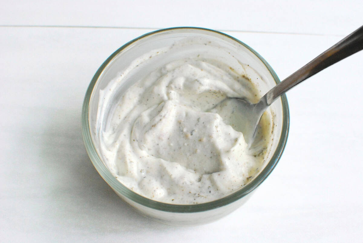 A light sour cream based spread in a small mixing bowl.