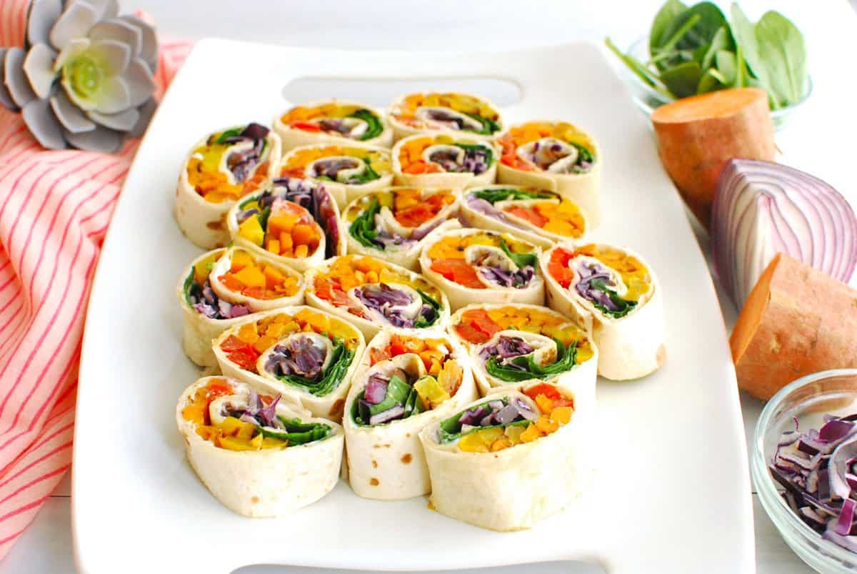 A platter with lots of rainbow vegetable pinwheels.