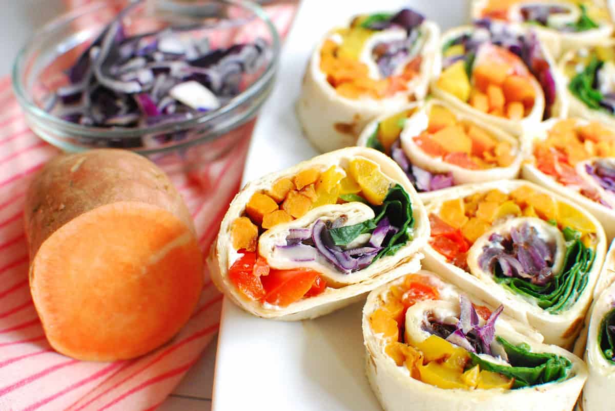 Colorful rainbow veggie pinwheels with fresh vegetables and creamy filling, perfect for healthy snac.