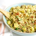A large bowl filled with spiced lamb, zucchini, and rice.