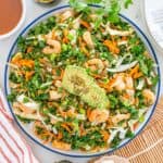 An overhead shot of a kale shrimp salad with miso dressing.