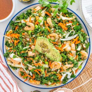 An overhead shot of a kale shrimp salad with miso dressing.