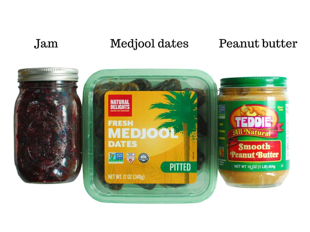 A jar of blackberry chia jam, a container of dates, and a jar of peanut butter.