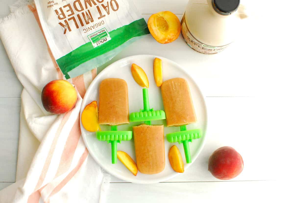 Three peach crisp ice pops on a plate.