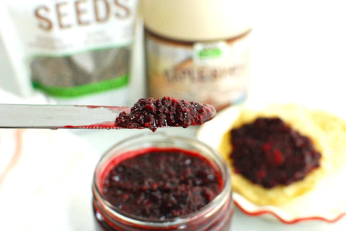 A knife with blackberry chia jam on it.
