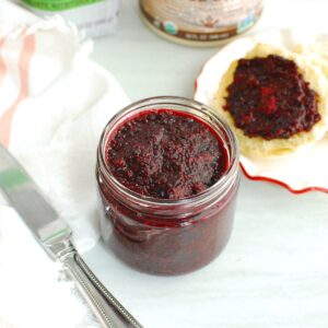 A jar of blackberry chia jam filled to the top.