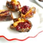 Peanut butter and jelly stuffed dates on a small plate.