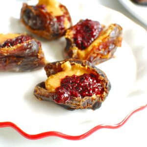 Peanut butter and jelly stuffed dates on a small plate.