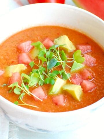 A white bowl filled with chilled watermelon gazpacho.