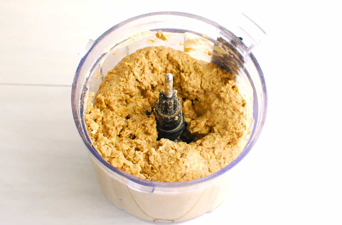 The combined energy ball mixture in the food processor bowl.