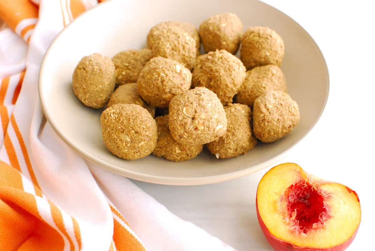 A bowl full of peach pie energy balls.