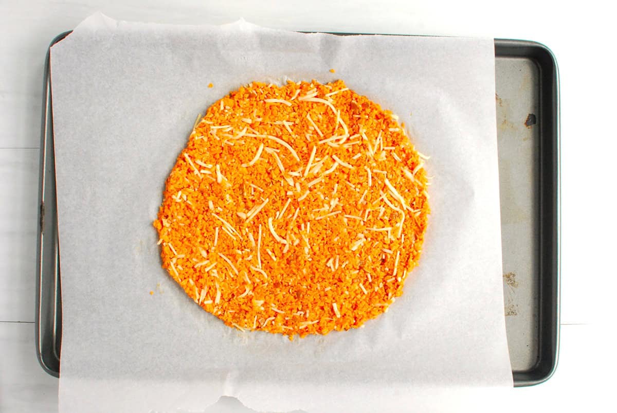 The sweetpotato mixture flattened into a circle onto a parchment lined baking sheet.