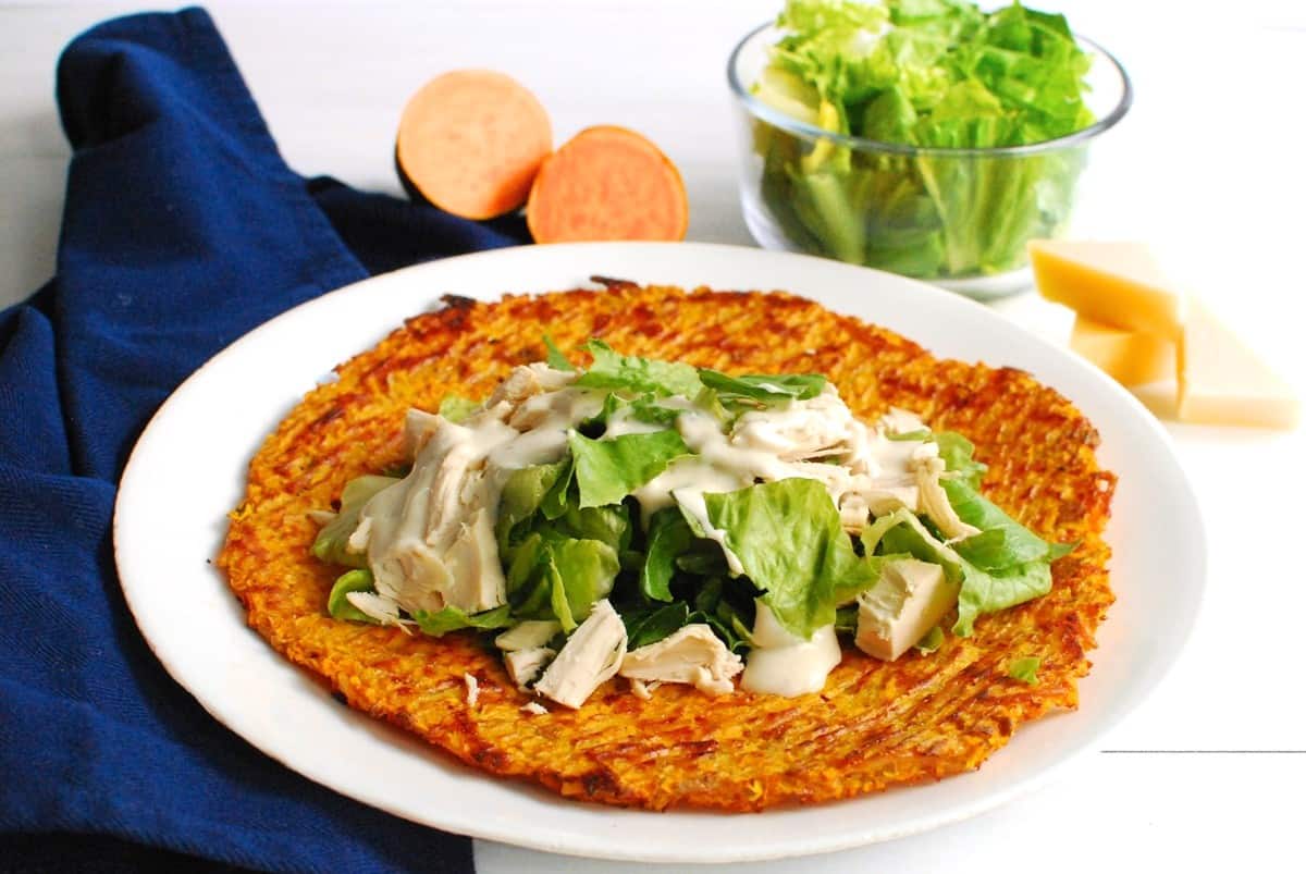 Chicken caesar salad placed onto the sweetpotato wrap.