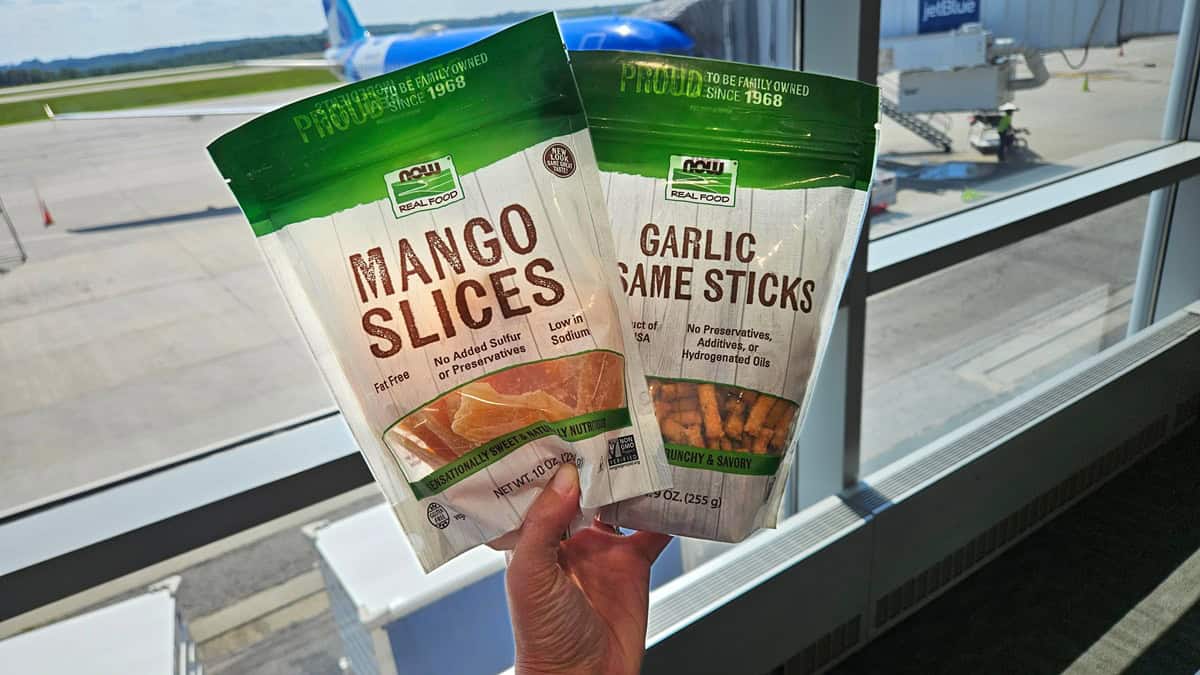 A package of dried mango and sesame sticks in an airport.