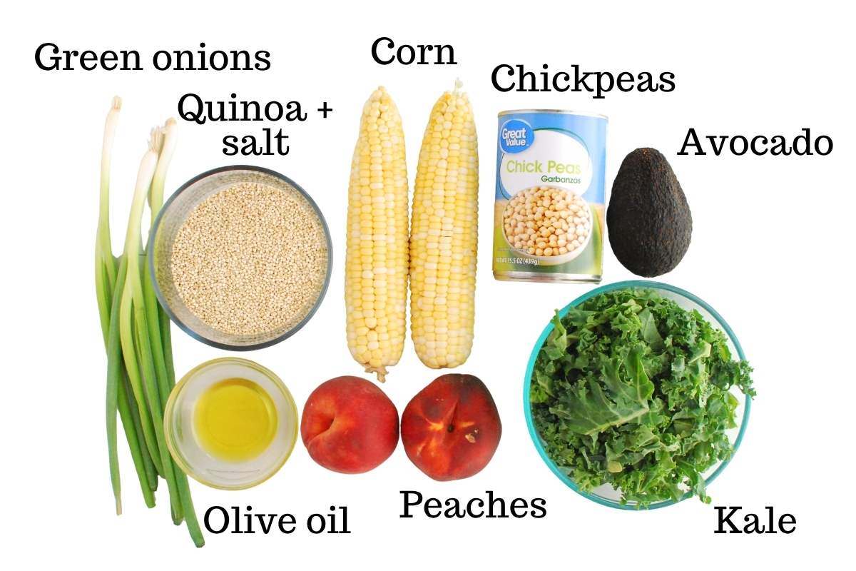 Quinoa, green onions, corn, peaches, kale, olive oil, chickpeas, and avocado, on a white backdrop.