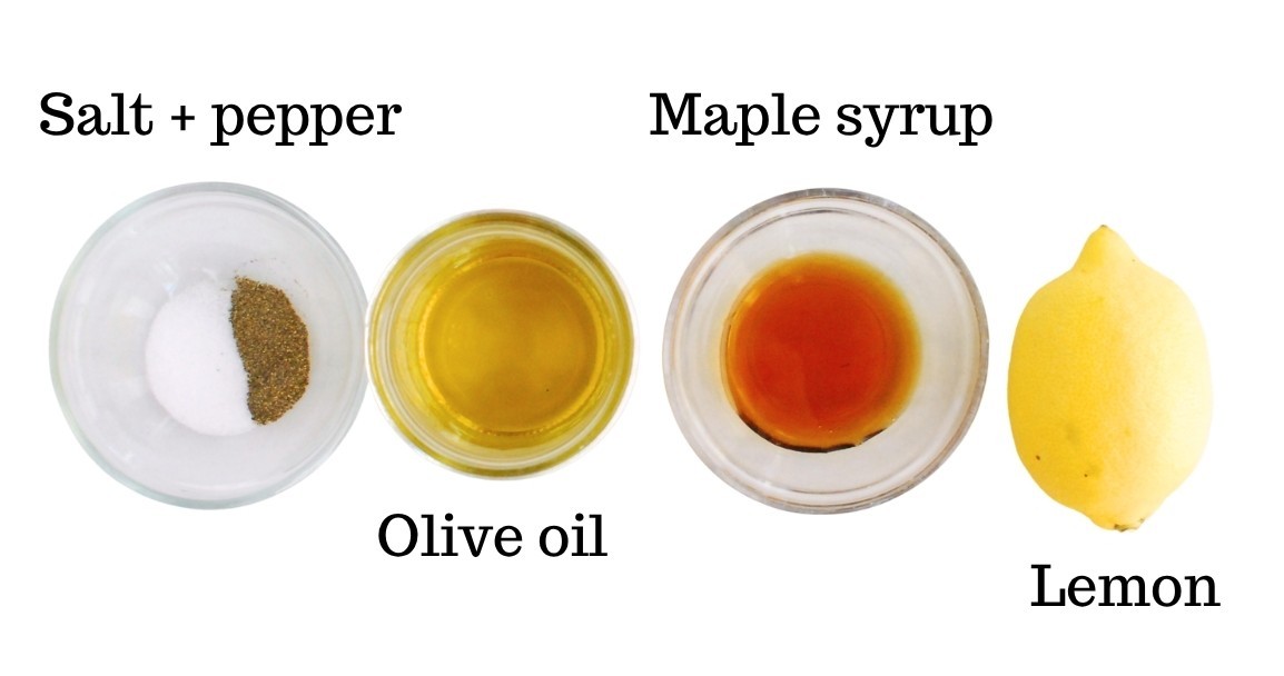 Oil, maple syrup, salt, pepper, and lemon, on a white backdrop.