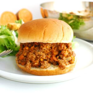 Beef and veggie sloppy joe mixture on a hamburger bun.