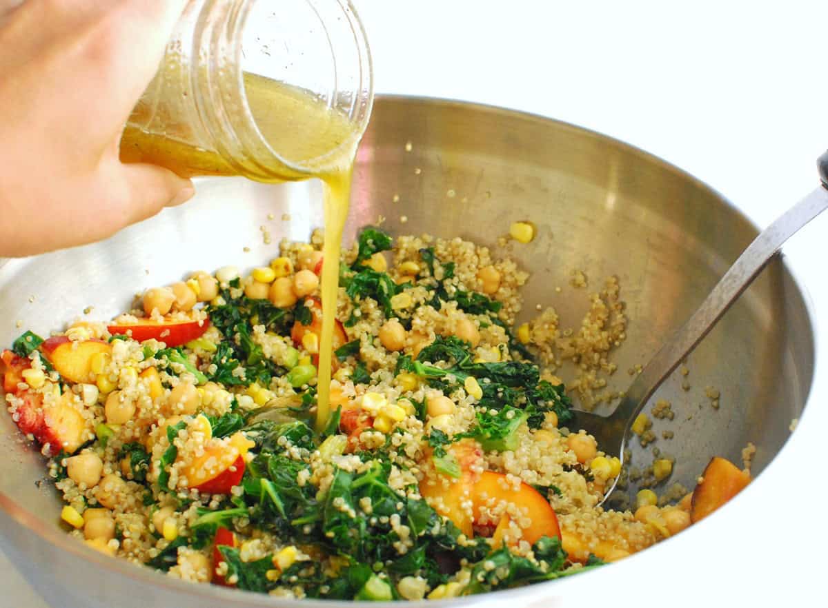 Dressing being poured over the salad.
