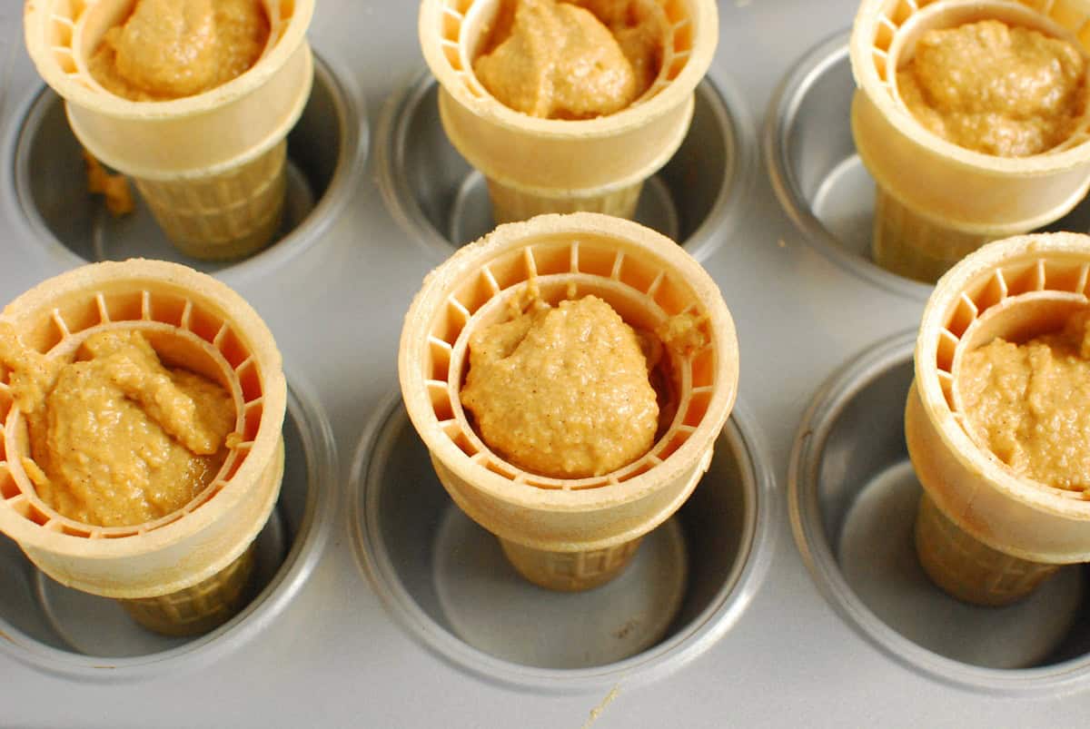 Ice cream cones filled with sweetpotato cupcake batter.