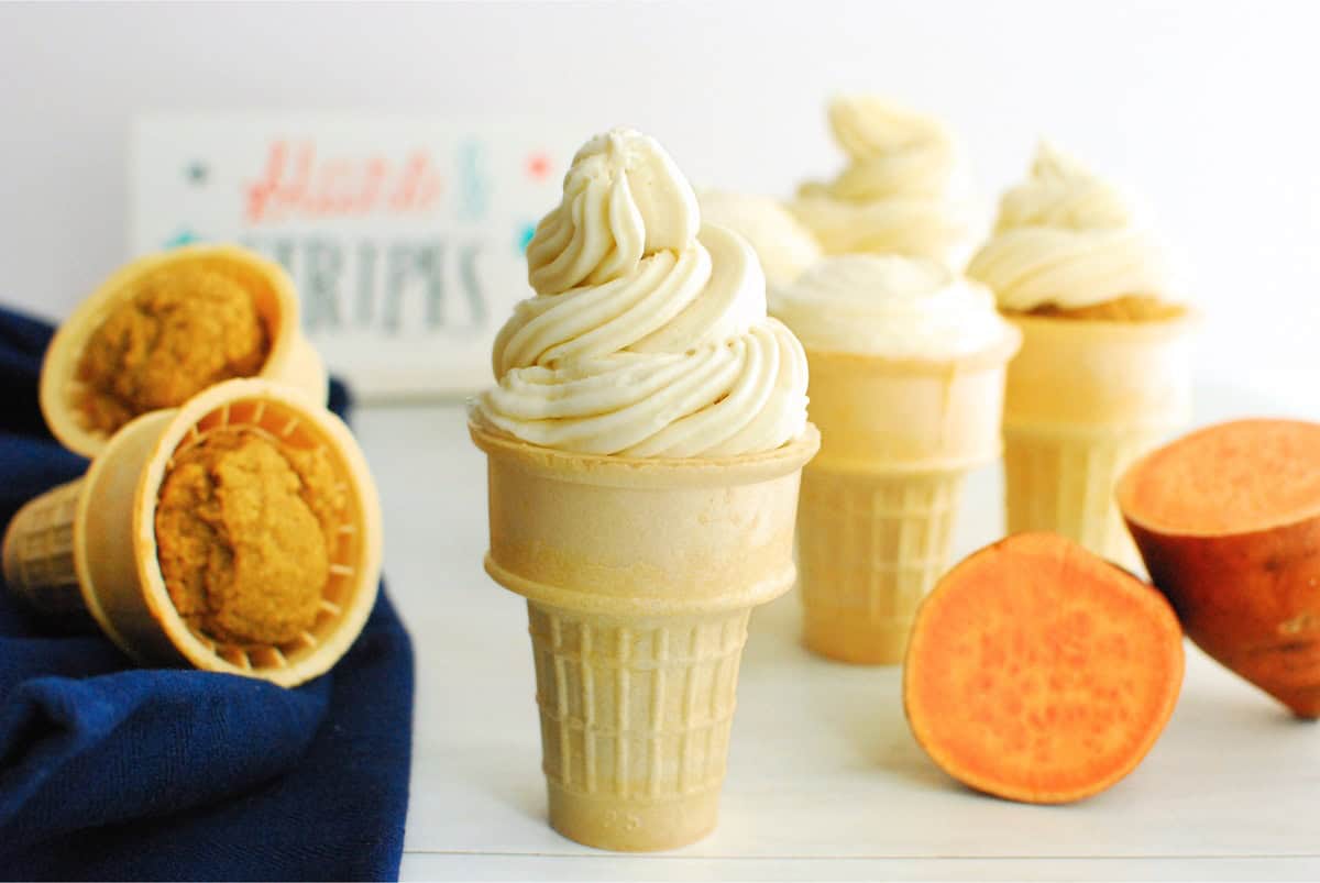 A sweetpotato ice cream cone cupcake with swirled frosting on top.